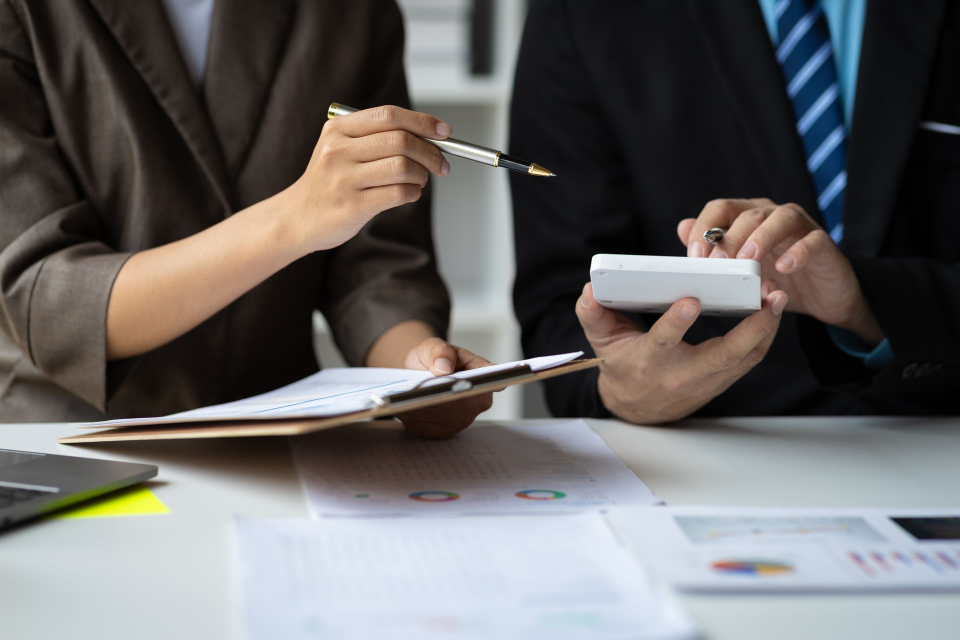 Coworkers are discussing company financial planning during a budget meeting. Business adviser meeting to discuss the situation on the financial report, accounting, investment.