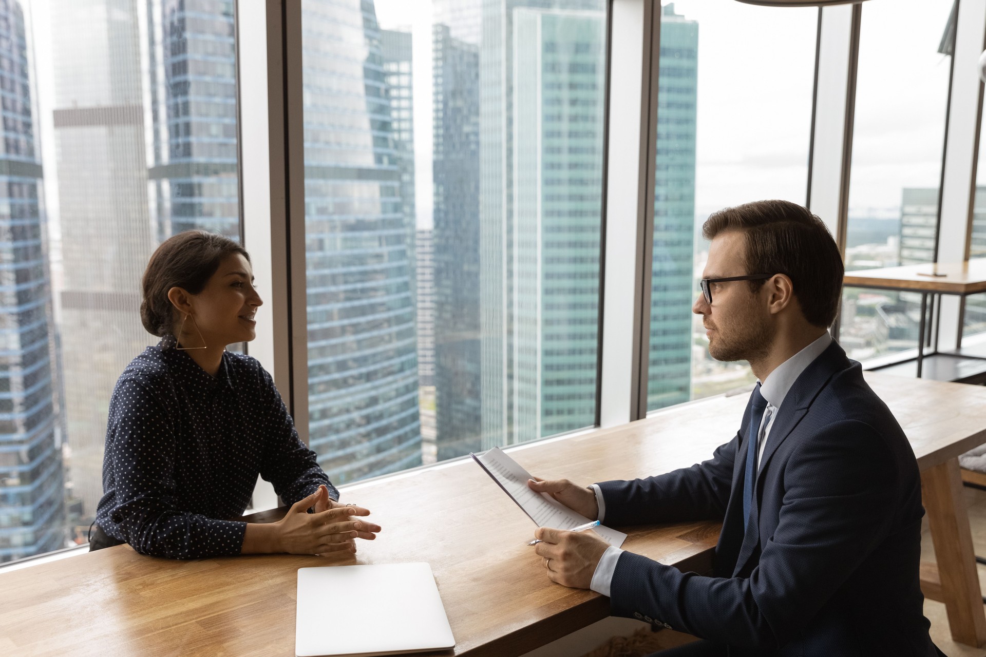 Multi ethnic young businesspeople negotiating in modern office